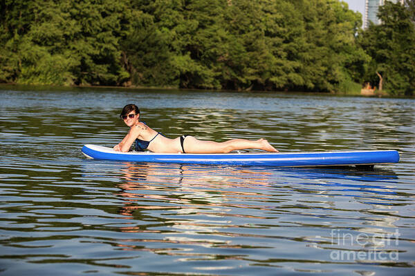 Woman Poster featuring the photograph A woman having a great time sunning for suntan by Dan Herron