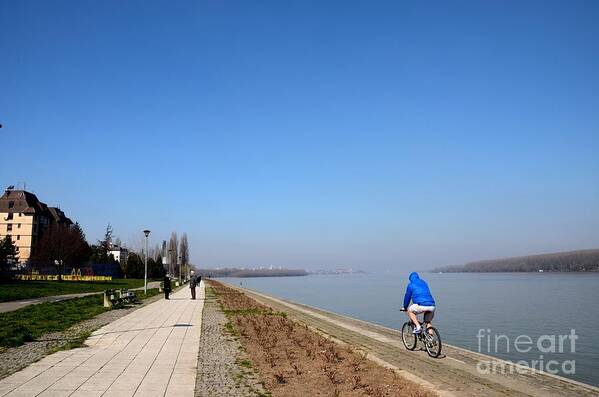 Sava Poster featuring the photograph Bicyclist and senior couple at bank of Sava River Belgrade Serbia by Imran Ahmed