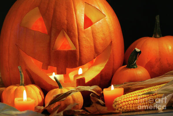 Agriculture Poster featuring the photograph Carved pumpkin with candles by Sandra Cunningham