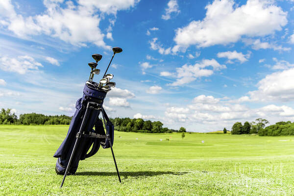 Golf Poster featuring the photograph Golf equipment bag standing on a course. by Michal Bednarek