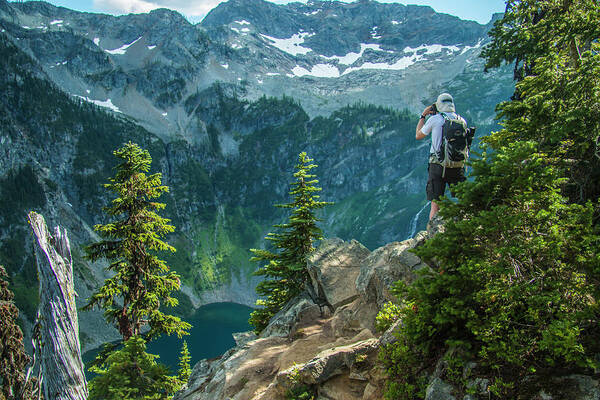 Photographer Capturing An Image High Above Rainy Lake Along The Maple Pass Trail In North Cascades National Park. Poster featuring the photograph Lakeside View by Doug Scrima