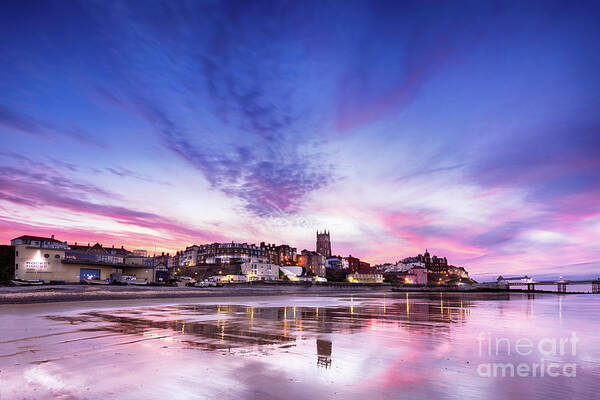 Cromer Poster featuring the photograph Pink sunset reflections over Cromer town at dusk by Simon Bratt