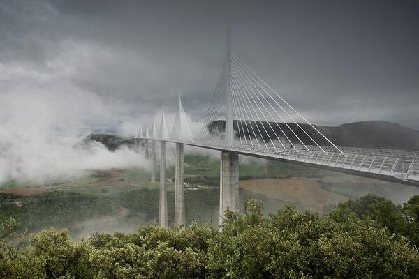 Millau Poster featuring the photograph Storm clouds roll in over the Millau viaduct by Stephen Taylor