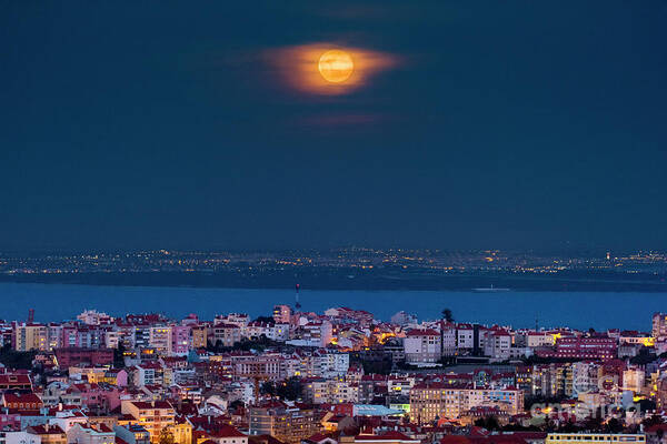 Moon Poster featuring the photograph Blue Moon Rising Over Lisbon #1 by Miguel Claro/science Photo Library