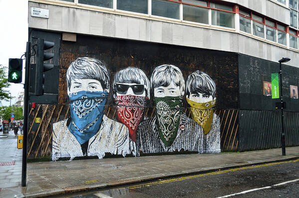 Bansky Poster featuring the photograph Yhe Beatles wearing face masks street mural in London by RicardMN Photography