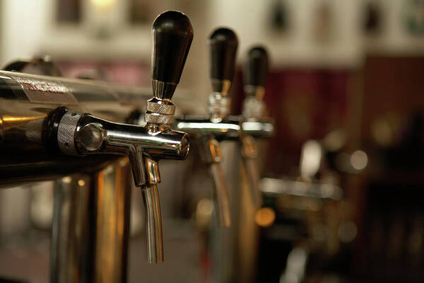 Blurred Motion Poster featuring the photograph Beer Taps At A Bar by Blue Jean Images