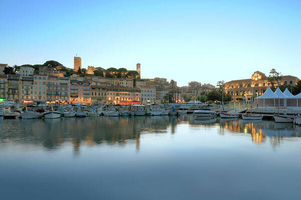 Water's Edge Poster featuring the photograph Cannes In The Evening Viewed From Harbor by Nikitje
