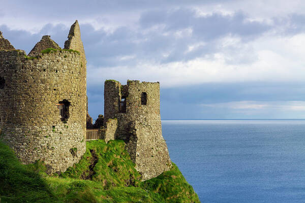Water's Edge Poster featuring the photograph Dunluce Castle by Sasar