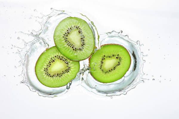 White Background Poster featuring the photograph Kiwi Slices Splash by Chris Stein