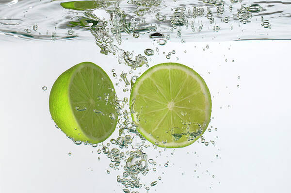 Vitamin C Poster featuring the photograph Lime Halves Submerged In Water by Photoalto/neville Mountford-hoare