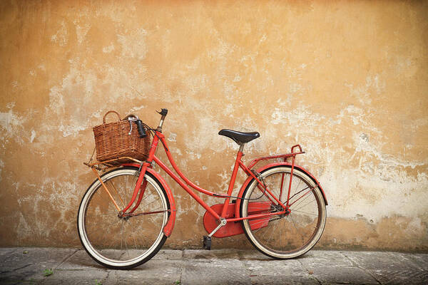 Leaning Poster featuring the photograph Old Red Bike Against A Yellow Wall In by Romaoslo