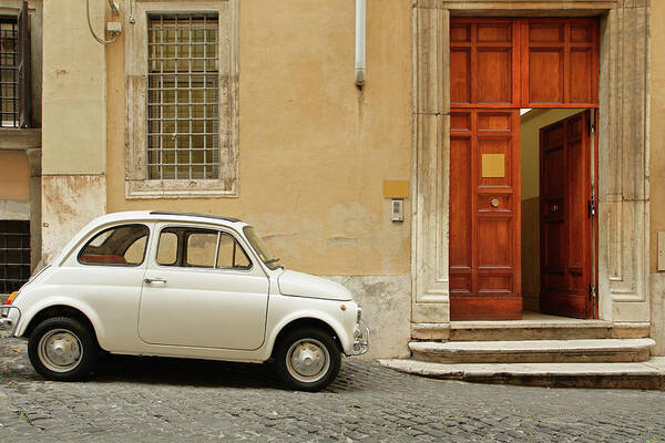 Steps Poster featuring the photograph Small Coupe Parked Near A Doorway On A by S. Greg Panosian