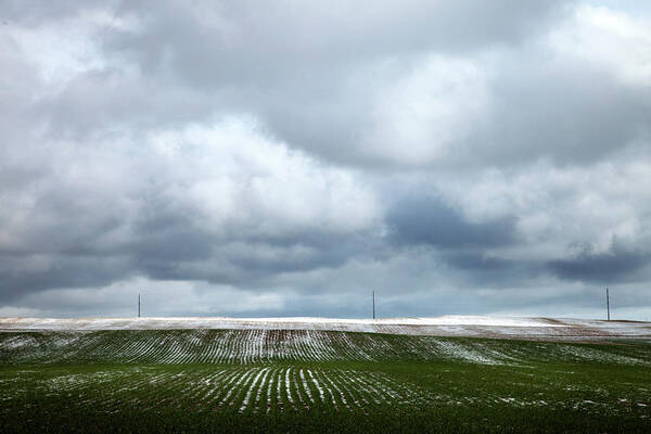 Snow Poster featuring the photograph Snow Dusted Field With Storm Coulds by Nivek Neslo