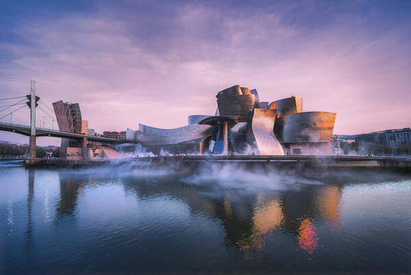#museum #guggemheim #frank Gehry #building #sunset #river #reflections #glare #architecture #steam Poster featuring the photograph Steamers by Jesus Concepcion Alvarado