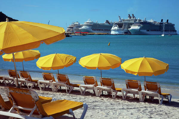 In A Row Poster featuring the photograph Sun Loungers And Sunshades On The Beach by Onfilm