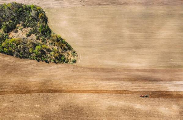 Landscapeaerial Poster featuring the photograph Tractor Plowing Field In Spring by Ryhor Bruyeu