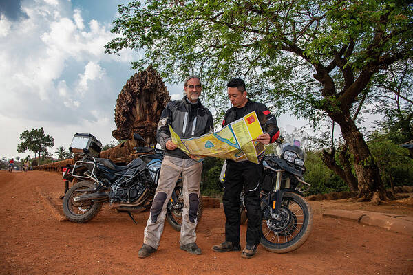 Motorcycle Poster featuring the photograph Two Men Looking At Map On An Adventure Motorbike Ride In Cambodia by Cavan Images