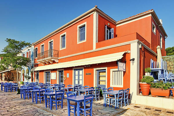 Fiscardo Poster featuring the photograph A fish restaurant at Fiskardo in Kefalonia, Greece by Constantinos Iliopoulos
