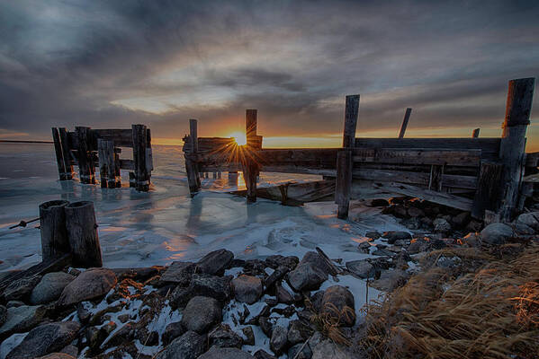 Pier Sunset Sun Sky Abandoned Ice Clouds Manitoba Hecla Island Poster featuring the photograph The Day Ends by Denise LeBleu