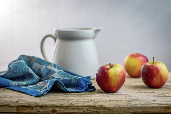 Drinking Glass Poster featuring the photograph Fresh apples on a rustic wooden table by Benoit Bruchez