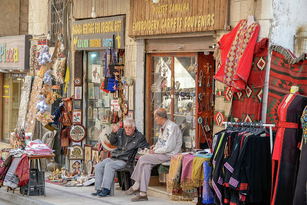 Jordan Poster featuring the photograph Merchants in Madaba, Jordan by Dubi Roman