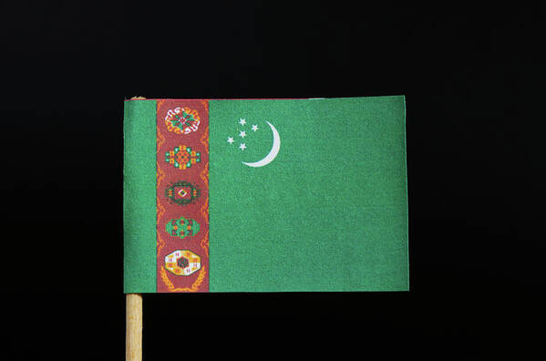 Poverty Poster featuring the photograph The national flag of Turkmenistan on toothpick on black background. A green field with a vertical red stripe near the hoist side by Vaclav Sonnek