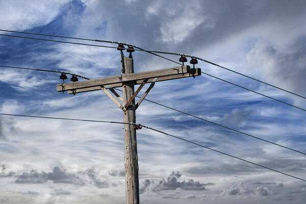 Power Poster featuring the photograph Utility Pole against a Cloudy Blue Sky by Randall Nyhof