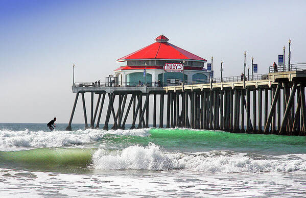 Surfing At Ruby�s Cafe On The Huntington Beach California City Pier Ocean Surfing Fine Art Photography Print Poster featuring the photograph Surfing At Rubys Cafe by Jerry Cowart