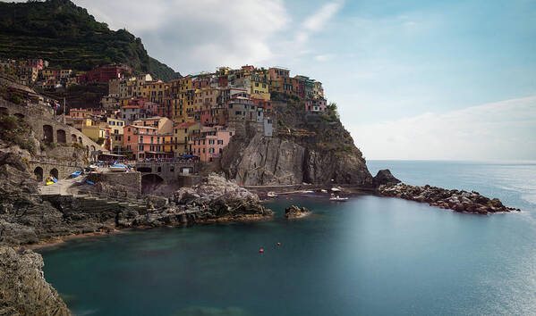 Cinque Terre Poster featuring the photograph Village of Manarola with colourful houses at the edge of the cliff Riomaggiore, Cinque Terre, Liguria, Italy by Michalakis Ppalis