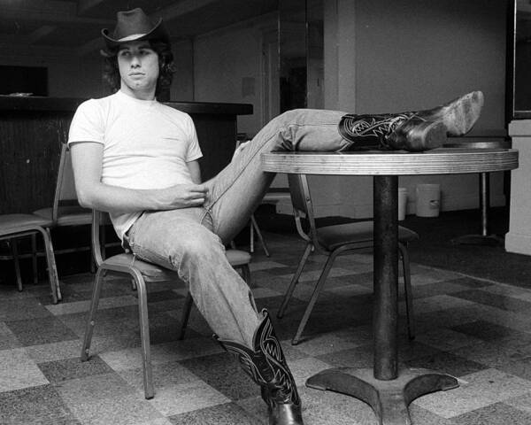 John Travolta Poster featuring the photograph John Travolta, With His Hat And Boots by New York Daily News Archive