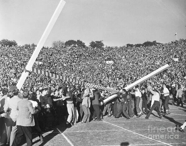Young Men Poster featuring the photograph Spectators Tearing Down Goal Post by Bettmann