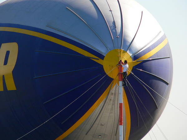 Goodyear Poster featuring the photograph Goodyear Blimp Nose Crewman by Jeff Lowe