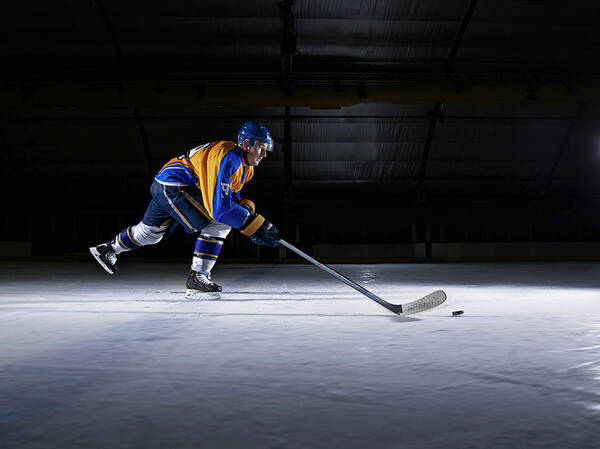Focus Poster featuring the photograph Male Ice Hockey Player Skating With by Mike Harrington