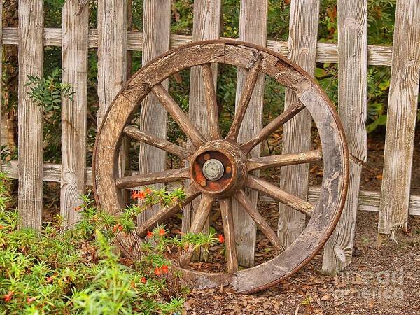 Wooden Wagon Wheel Poster featuring the photograph Old Spare Wheel by Chris Thaxter