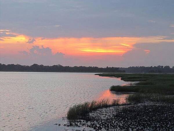  Poster featuring the photograph River's Edge Sunset by Joetta Beauford