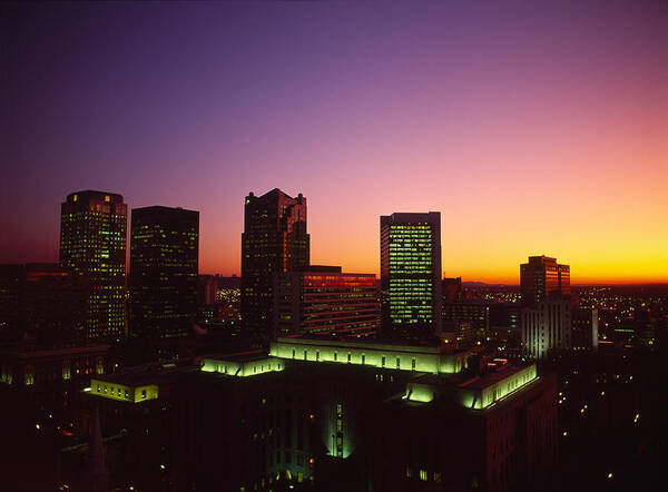 Photography Poster featuring the photograph Buildings In A City At Dusk #1 by Panoramic Images