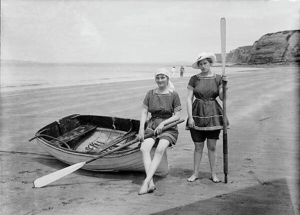 Beach Poster featuring the photograph Two Female Bathers, Rowboat On The Beach by Science Source
