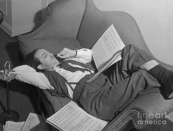 People Poster featuring the photograph Walt Disney Lounging And Reading Script by Bettmann