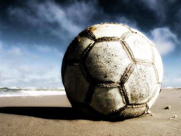 Shadow Poster featuring the photograph Worn And Old Soccer Ball On Sand by Vithib