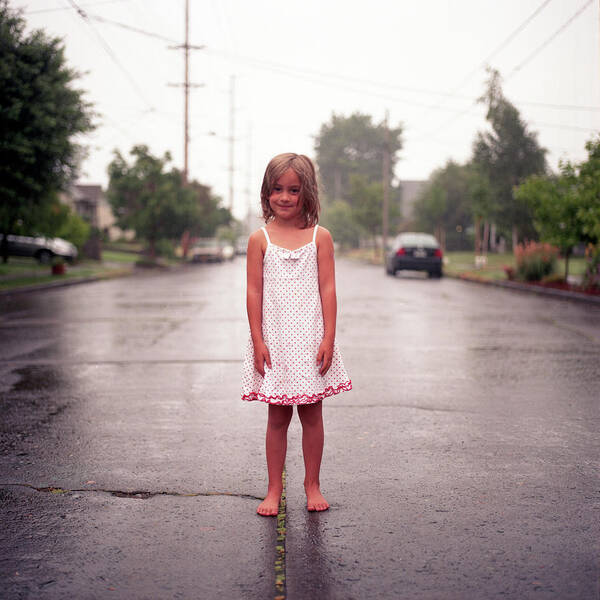 4-5 Years Poster featuring the photograph Girl In Rainy Street by By John Carleton