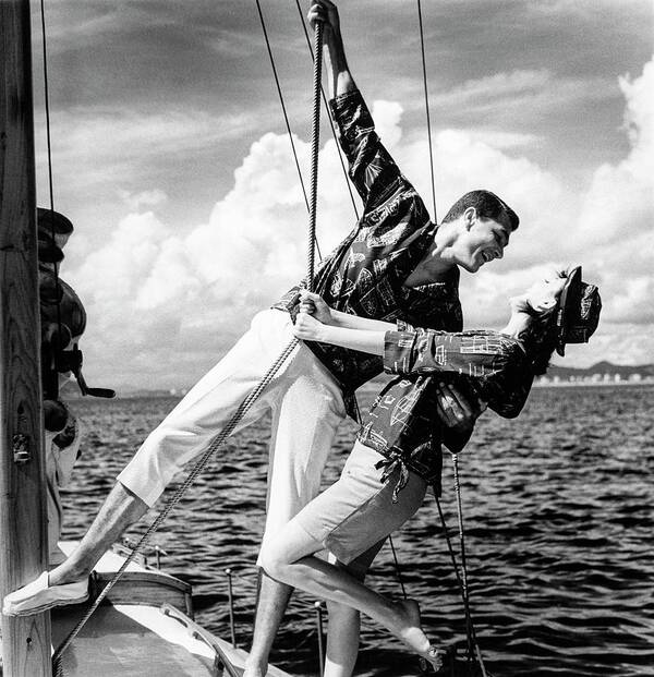 Outdoors Poster featuring the photograph Models Wearing A Bennett Shirts On A Sailboat by Richard Waite