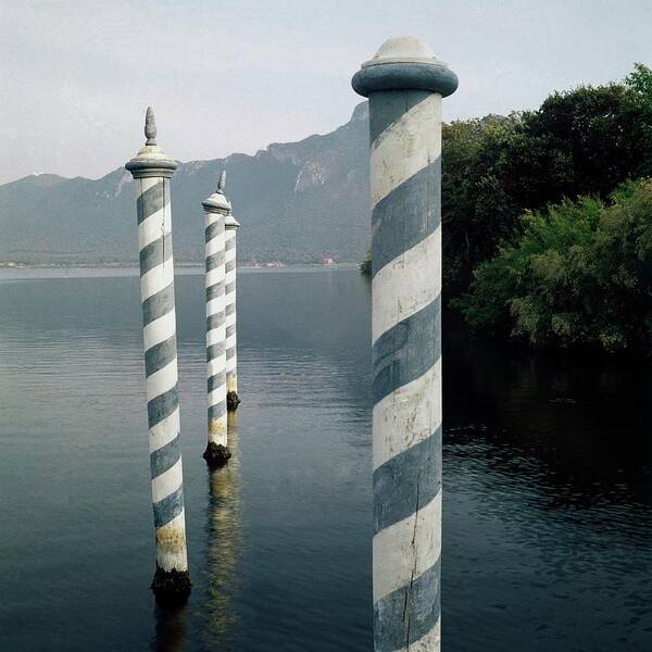 Sabaudia Poster featuring the photograph Striped Posts In The Grand Canal by Leombruno-Bodi