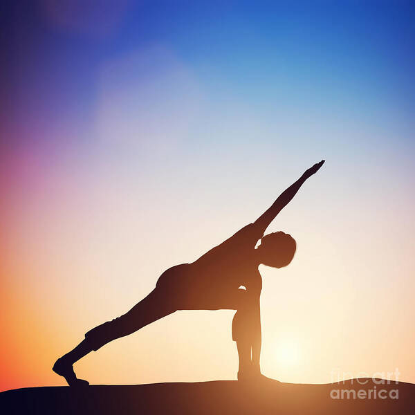 Yoga Poster featuring the photograph Woman standing in revolved side angle yoga pose meditating at sunset by Michal Bednarek