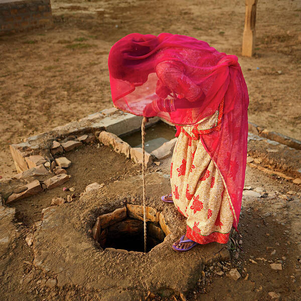 Working Poster featuring the photograph Indian Woman Getting Water From The #1 by Hadynyah