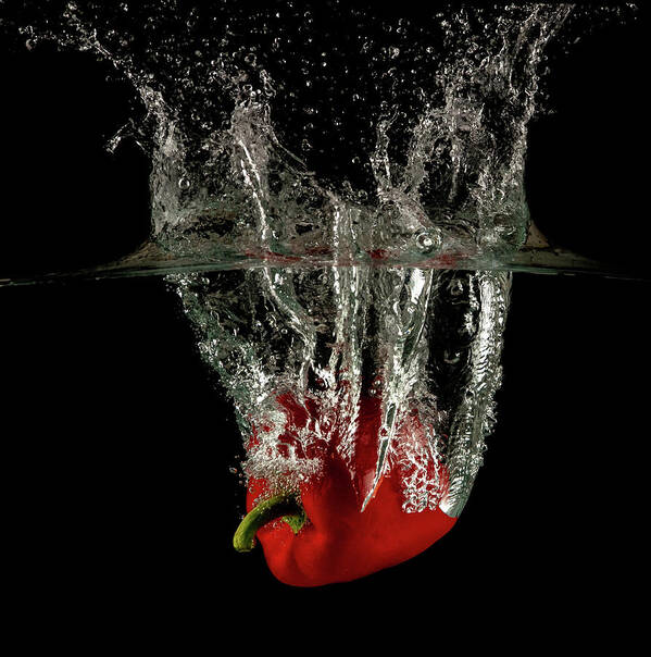 Pepper Poster featuring the photograph Red bell pepper dropped and slashing on water by Michalakis Ppalis