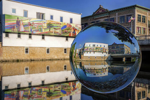 Stoughton Wi Wisconson Mural Yahara River Glass Sphere Water Horizontal Buildings Art Print featuring the photograph Stoughton Downtown Mural on Yahara River by Peter Herman
