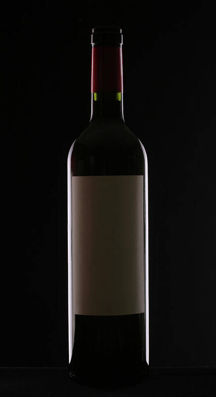 Alcohol Art Print featuring the photograph Bottle Of Red Wine On Black Background by Donald gruener