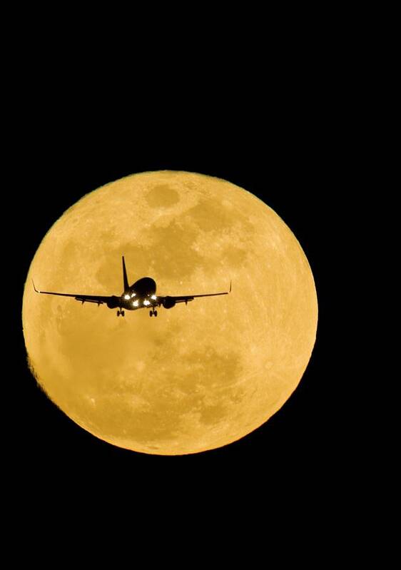 Moon Art Print featuring the photograph Aeroplane Silhouetted Against A Full Moon #1 by David Nunuk