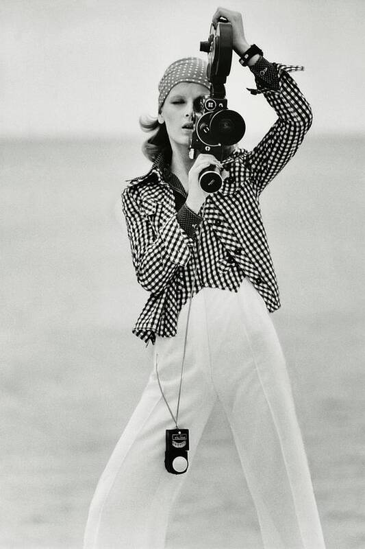Fashion Art Print featuring the photograph A Model Looking Through A Beaulieu Camera Wearing by Gianni Penati