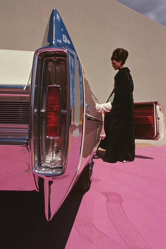 Auto Art Print featuring the photograph A Model Wearing Emeric Partos Entering A 1965 by Gene Laurents